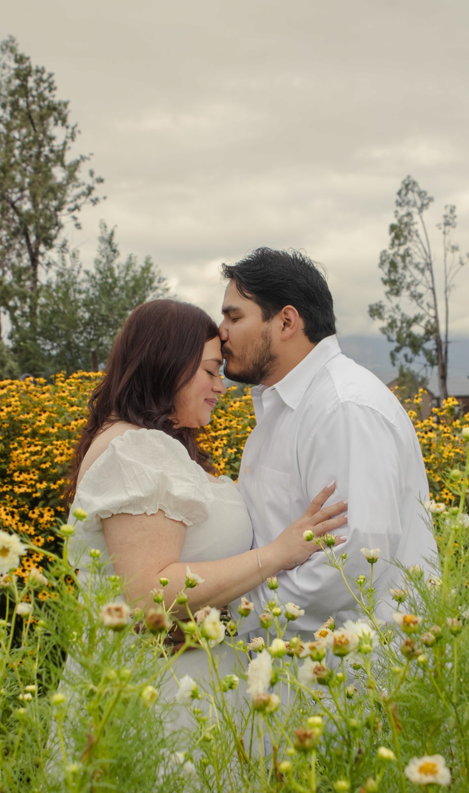 A couple embracing in a Colorado wildflower meadow
