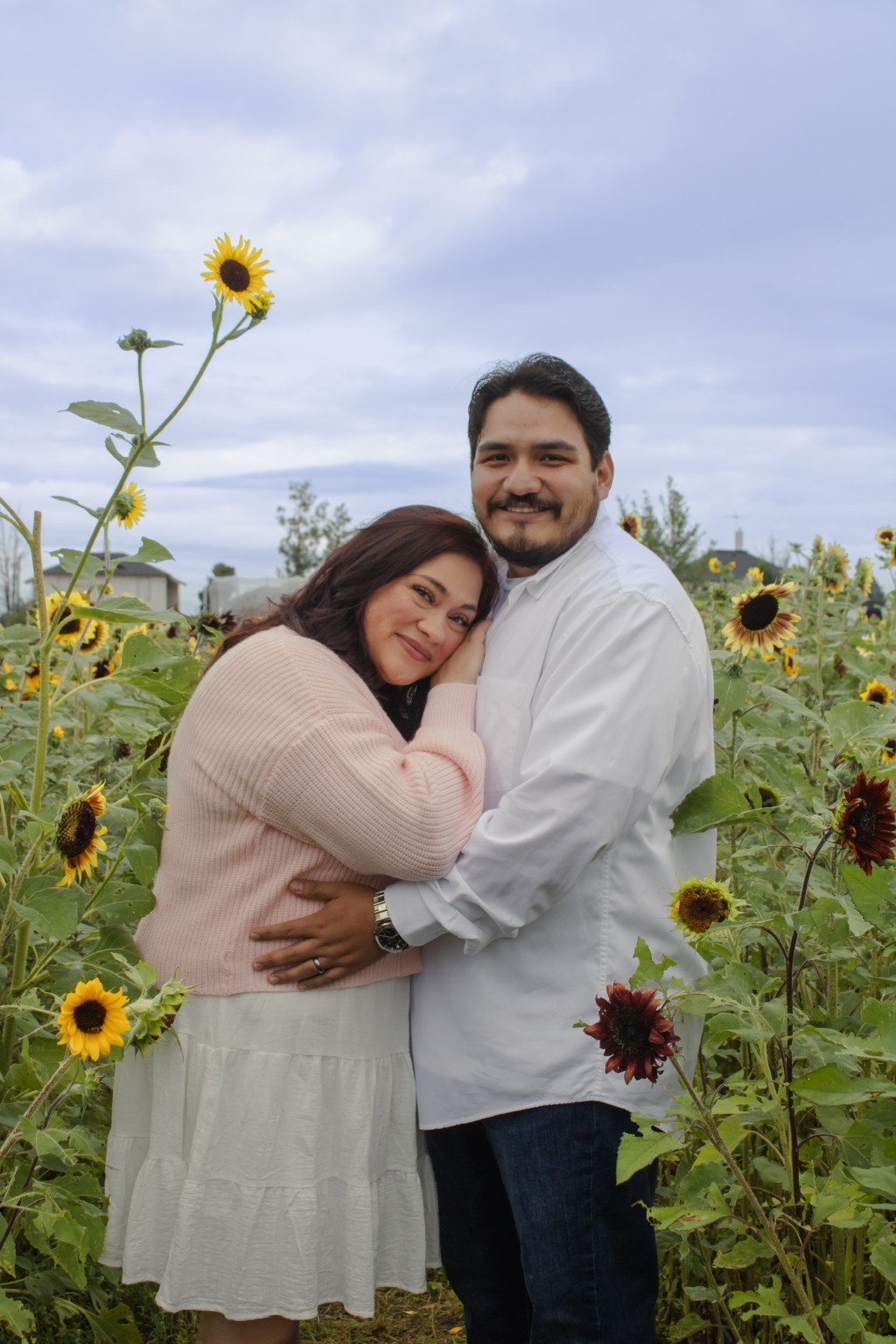 An embrace surrounded by sunflowers