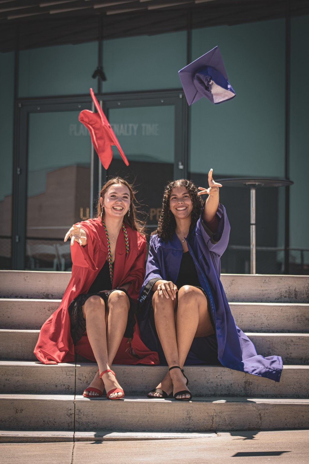 Graduates tossing their caps on the steps